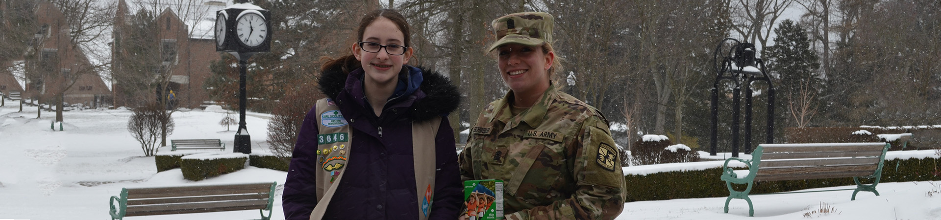  Girl Scout with a soldier holding a box of thin mints 